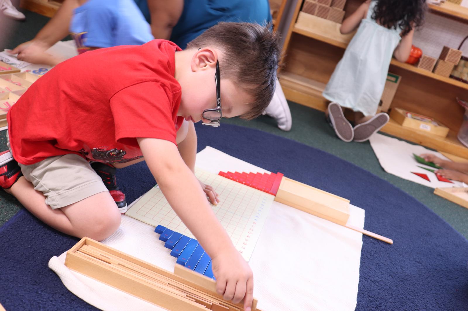 Montessori teacher guiding independent learning at Palm Grove in Plano TX